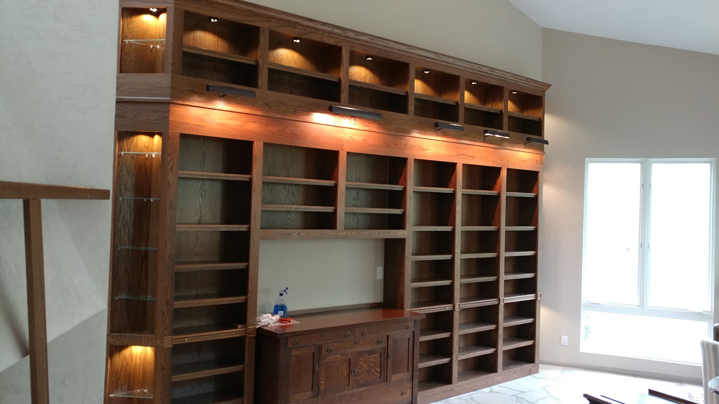 Custom entertainment center with integrated storage by Professional Wood Interiors - St. Louis, MO
