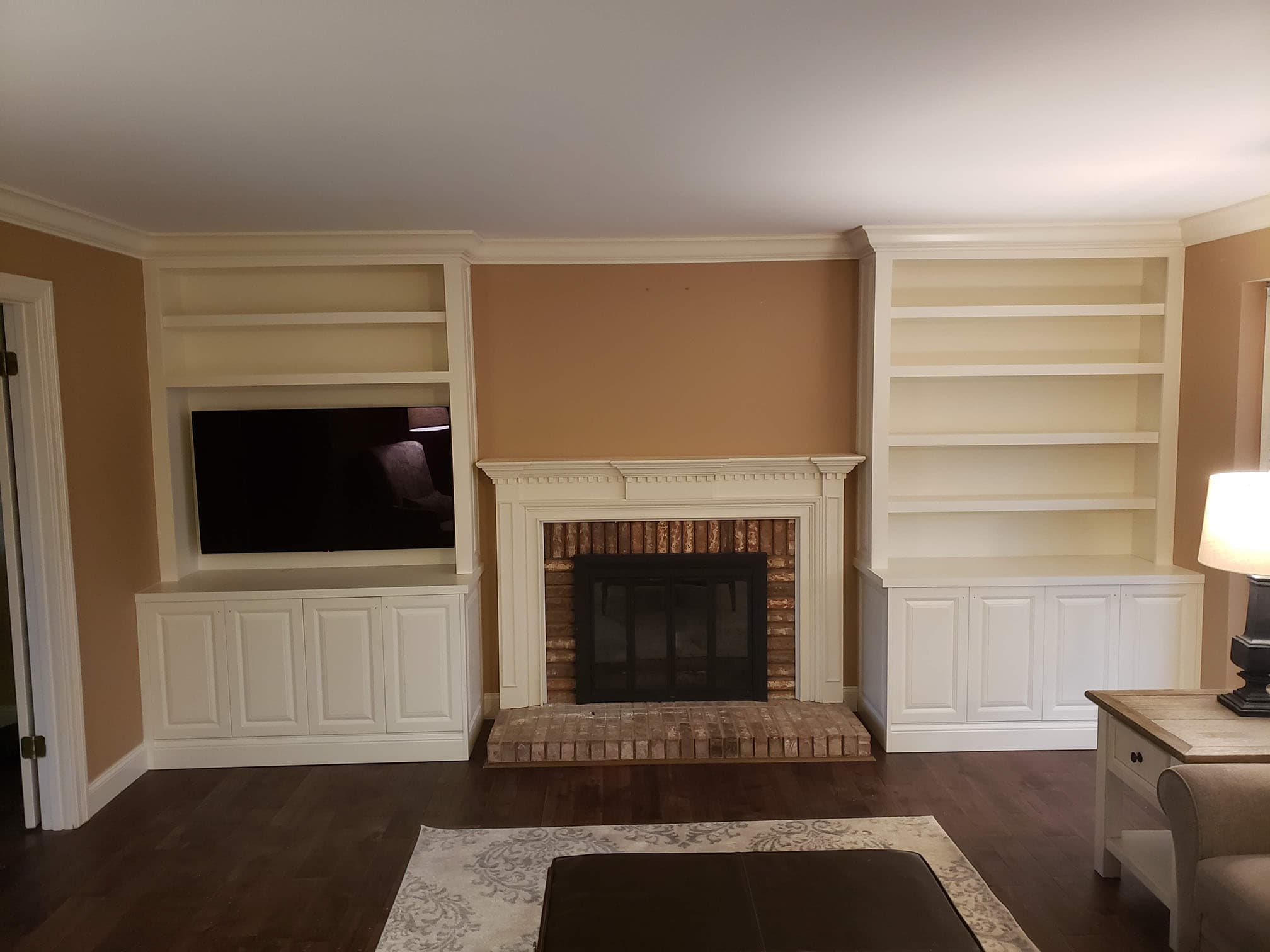 Custom entertainment center and media cabinet featuring entertainment fireplace remodel by Professional Wood Interiors - St. Louis, MO